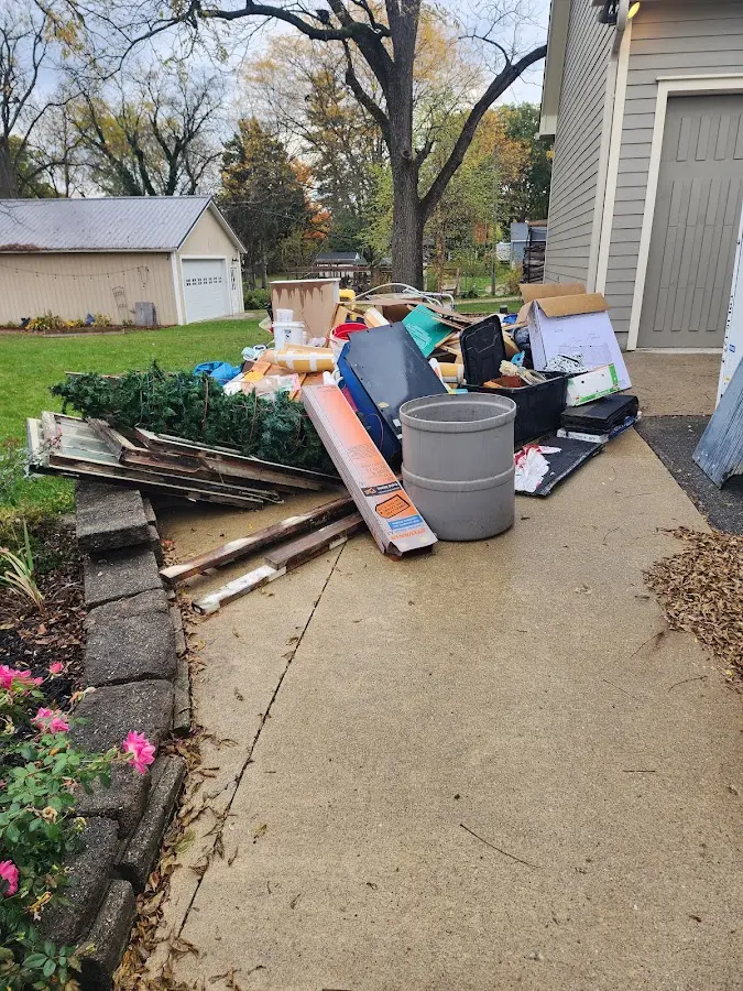 Dumpster being loaded with debris for 12 Yard Dumpster Rental in Beacon Falls